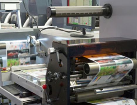 An offset machine producing printed colored photos